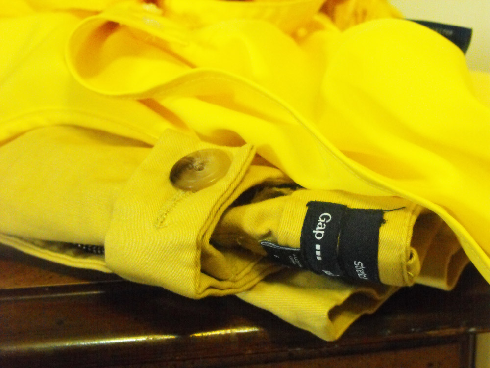 Gap yellow stretch pants folded on table