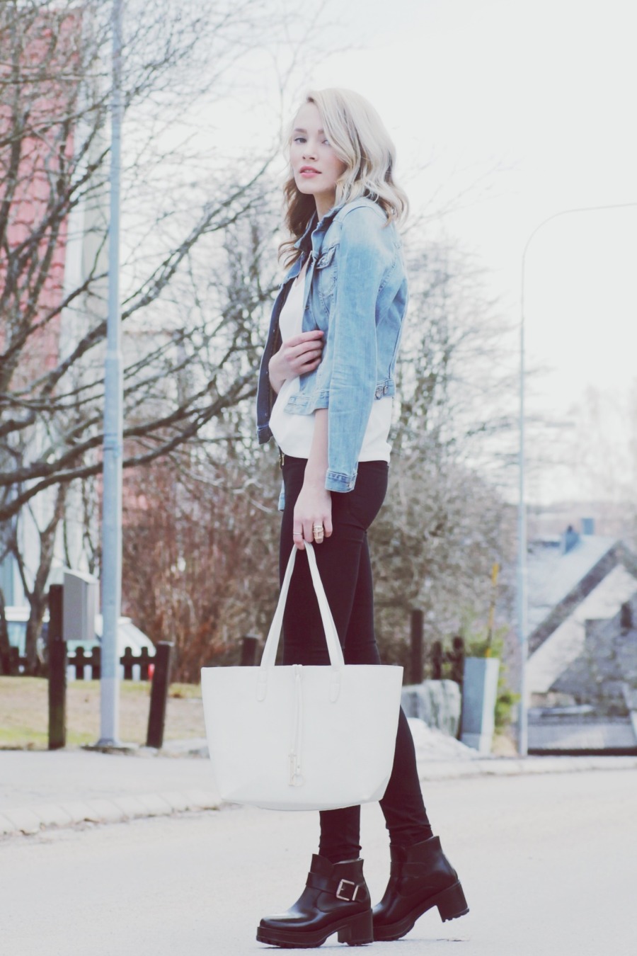 Petra Karlsson wearing skinny jeans white top blue denim jacket black ankle boots white bag