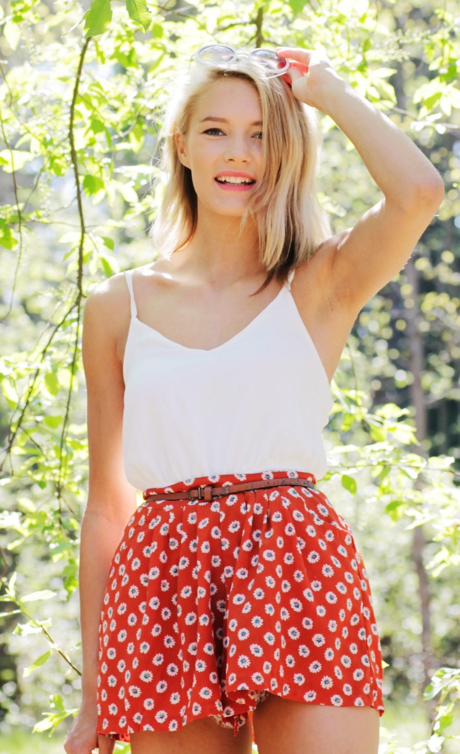 Petra Karlsson wearing white tank top and red print skirt
