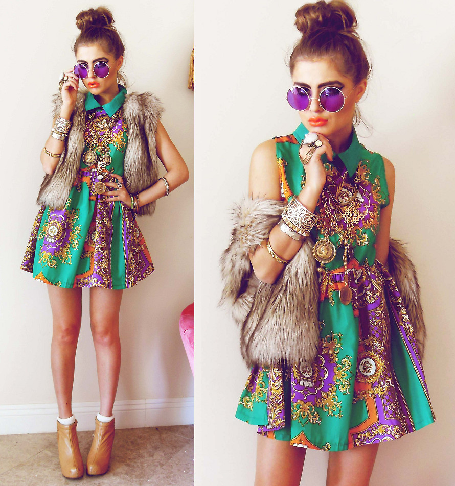 Blogger Bebe Zeva wears a green and purple print dress accessorized with purple lens sunglasses