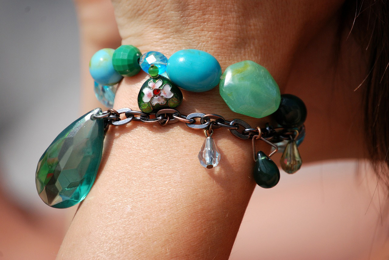 girl wearing charm bracelet with turquoise beads