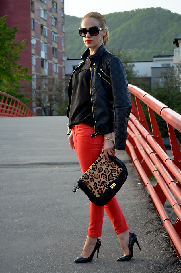 Lavinia F from the blog Loving Evelyn wears red skinny jeans with a black chiffon blouse
