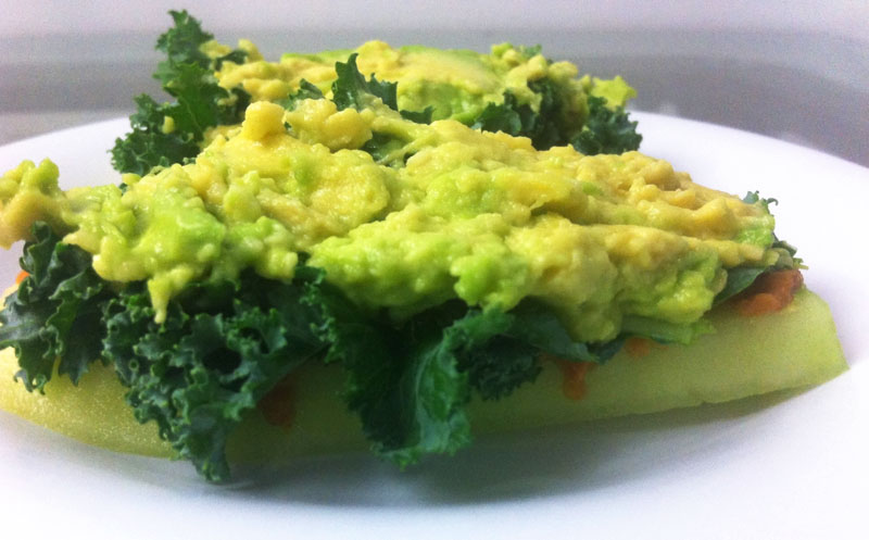 kale on cucumber slice with peanut butter spread and avocado