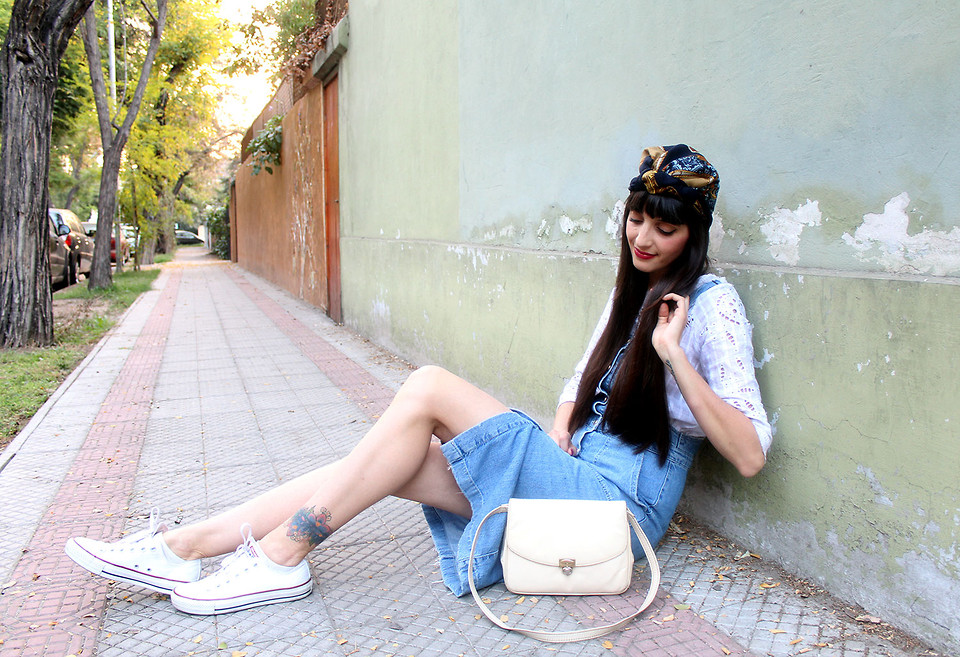 Fashion Blogger and designer Paz Halabi Rodriguez from Chile wearing Converse canvas sneakers with a denim pinafore dress