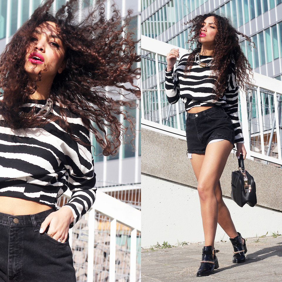 From Hats to Heels fashion blogger Larissa Bruin wears black cut off jeans shorts with a zebra printed cropped top