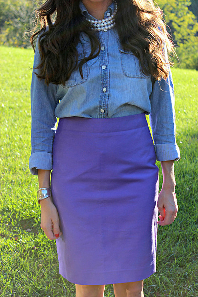 Baubles to bubbles blogger Olivia wears a blue denim shirt with a purple pencil skirt