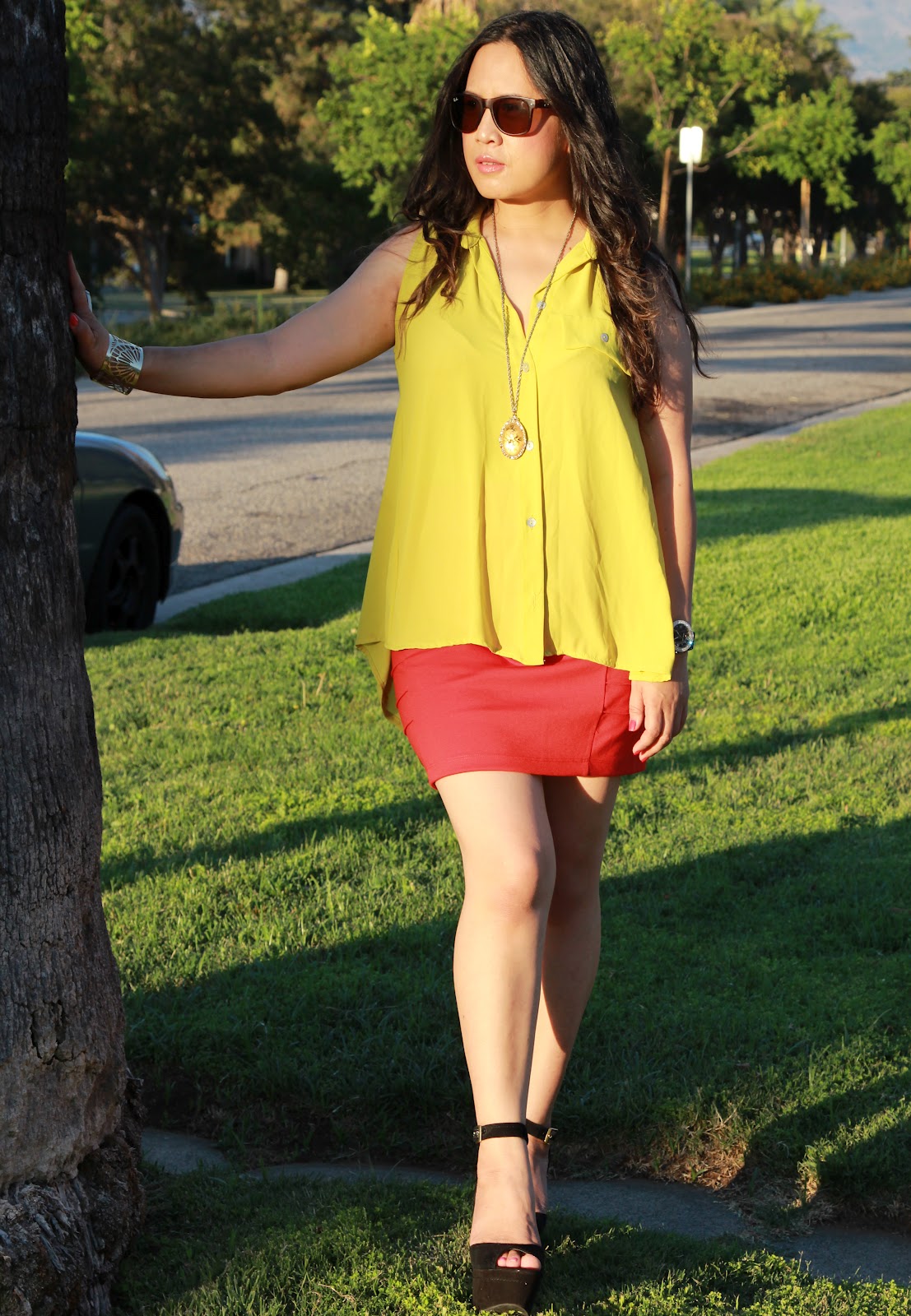Joice from the blog Love Joice wearing a yellow top with a red skirt