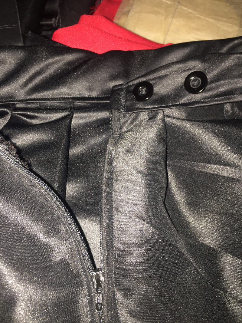 black pleated skirt zipper and button fastening