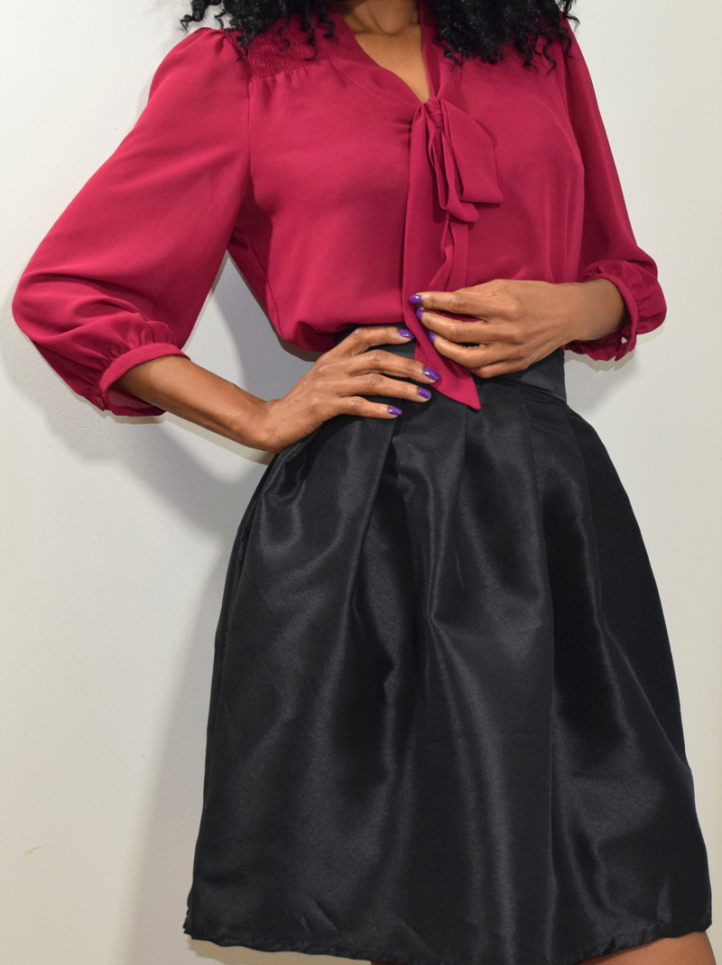 the black skirt with burgundy top
